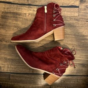 Dark red boots with laced up details.